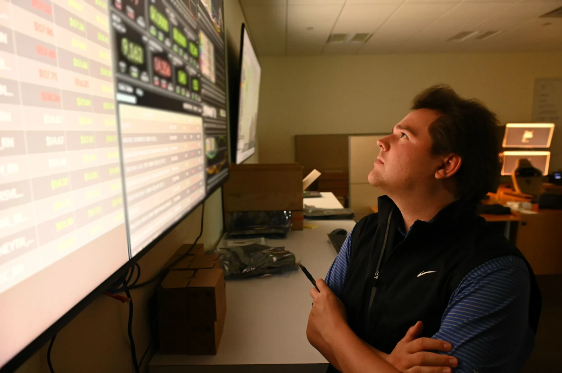 Image of a person monitoring data in a network operations center.